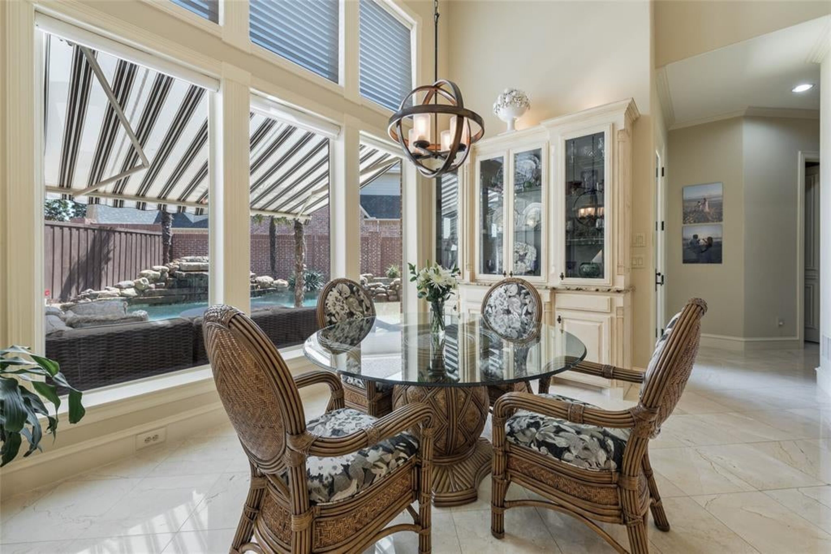 The dining room offers a view to the patio and pool.