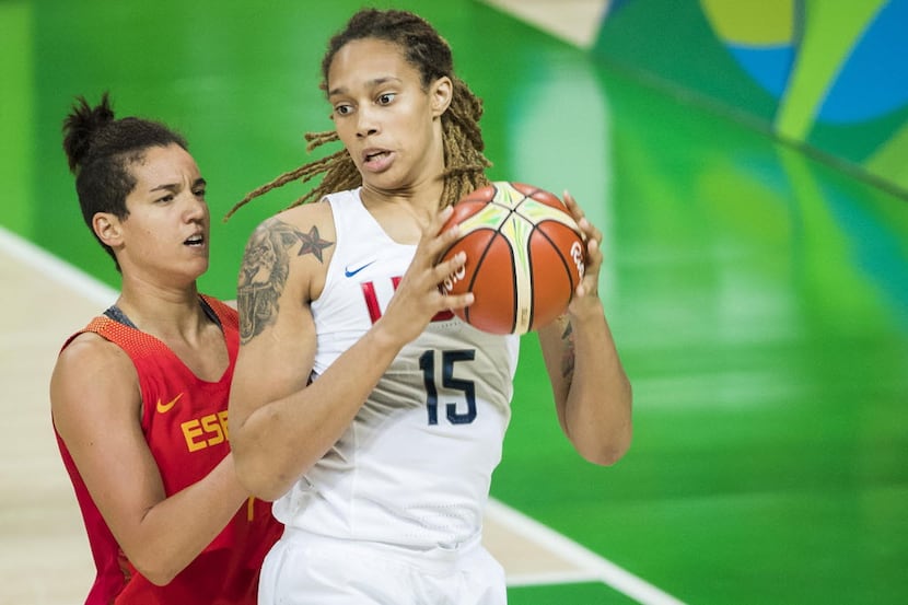 Brittney Griner (15) of United States grabs a rebound away from Laura Nicholls (4) of Spain...