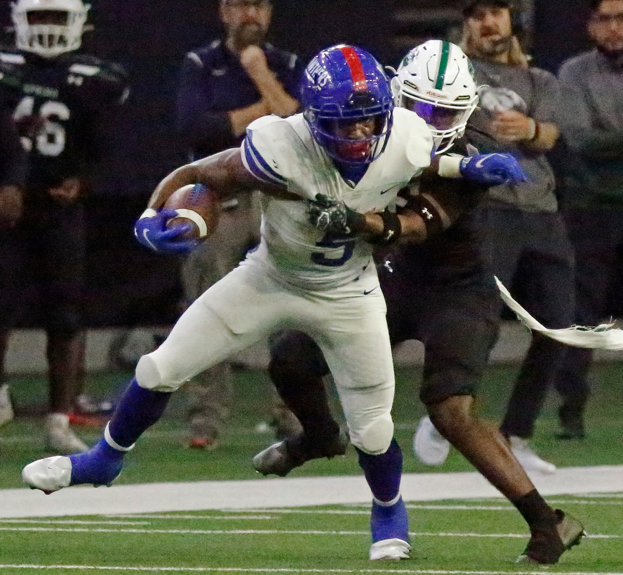 Duncanville High School running back Malachi Medlock (5) is held up by Spring High School...