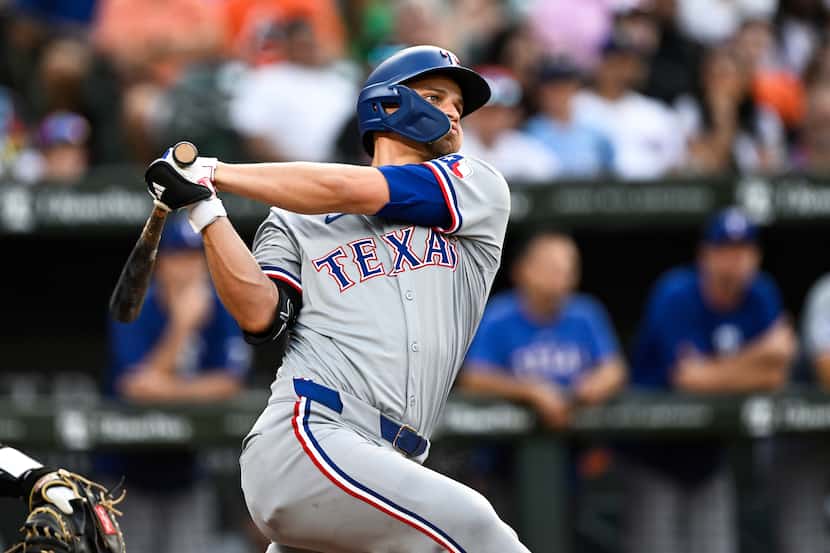 Texas Rangers' Corey Seager watches his solo home run off Baltimore Orioles pitcher Cade...