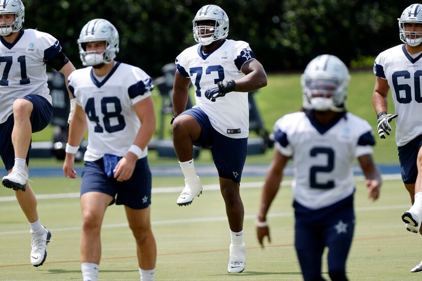 Dallas Cowboys offensive tackle Tyler Smith (73) runs through drills with the offense during...