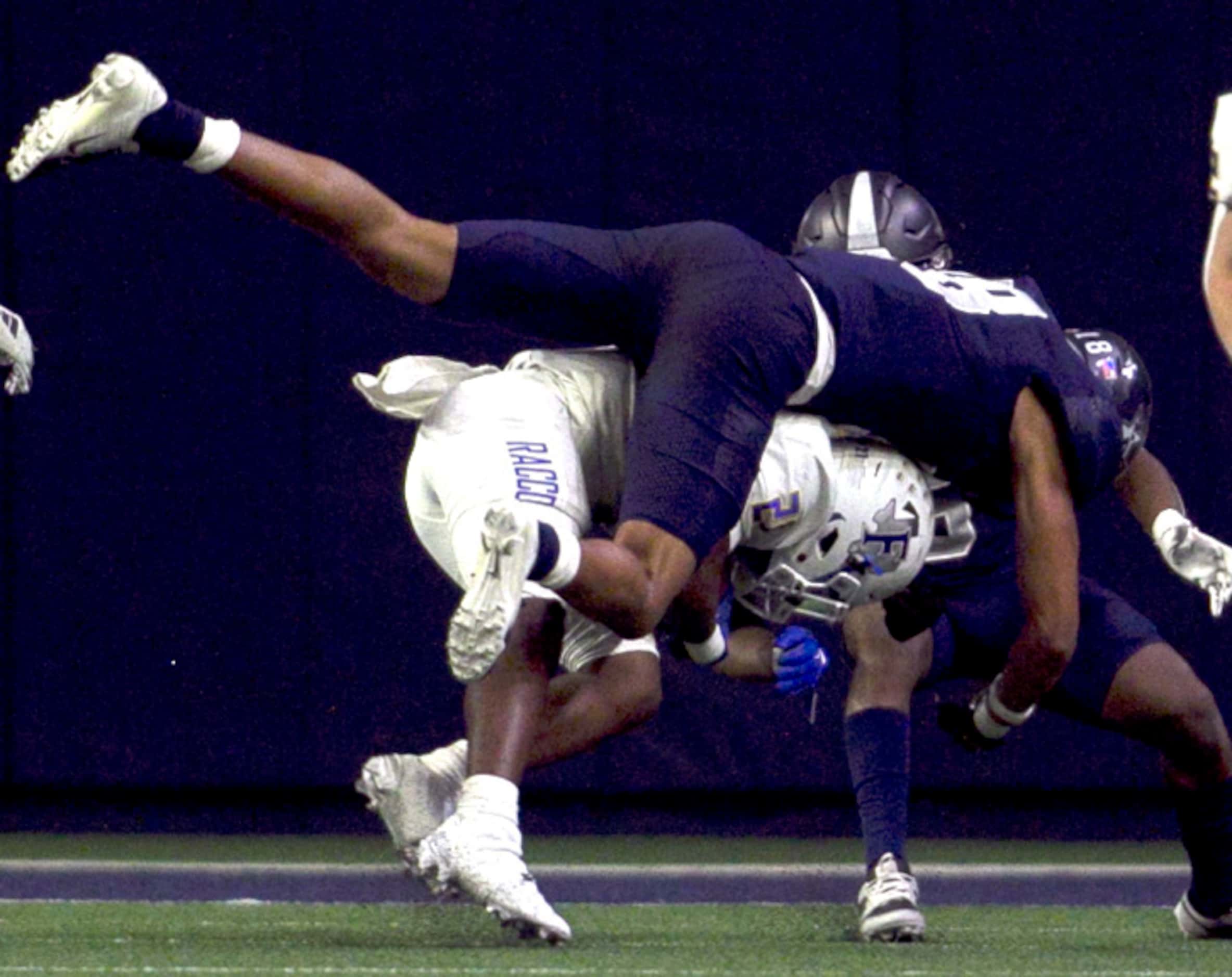 Frisco Lone Star defender Jordan Deck (18) takes a flying leap approach to tackling Frisco...