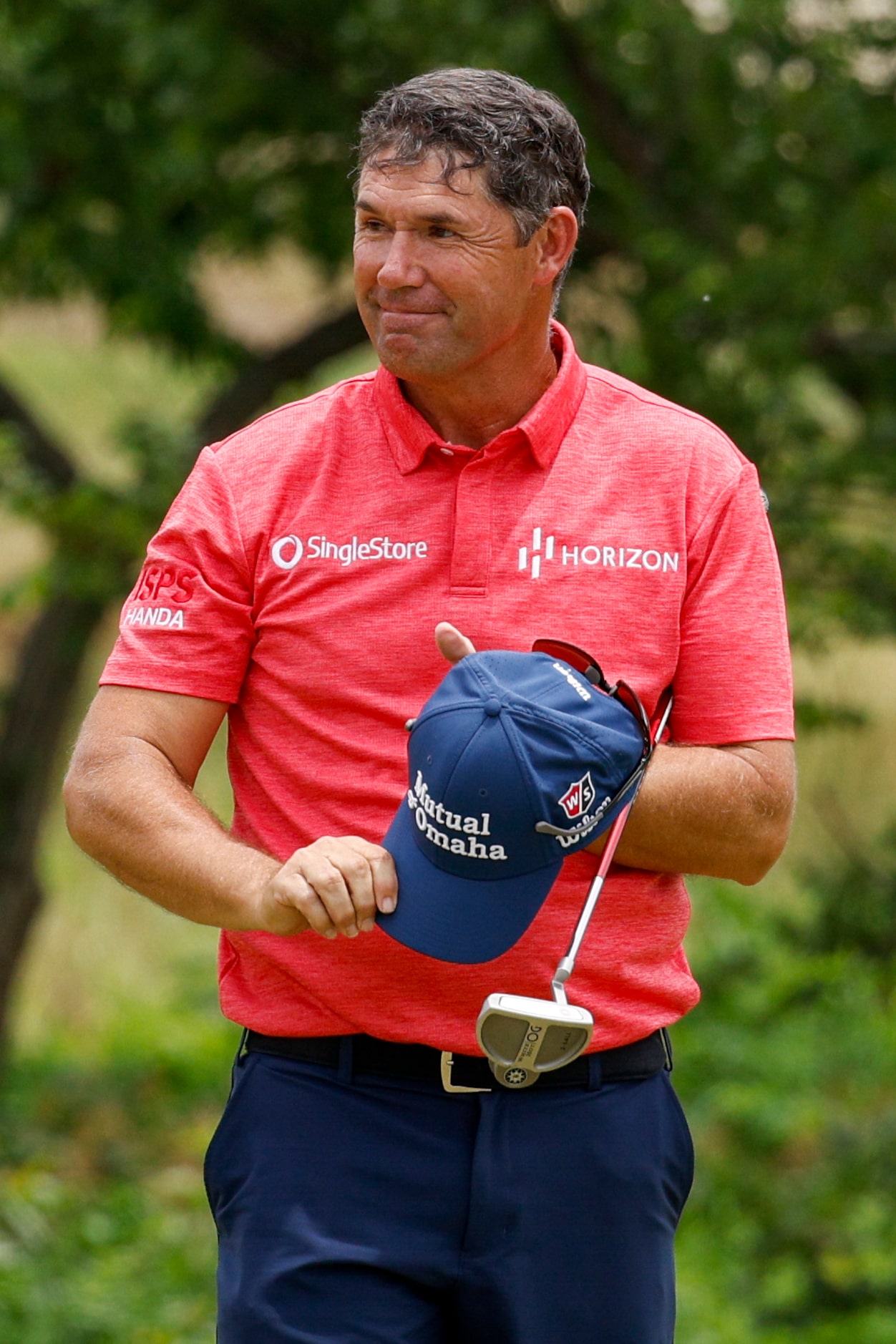 Padraig Harrington of Ireland smiles after making a birdie putt on the 18th hole during the...