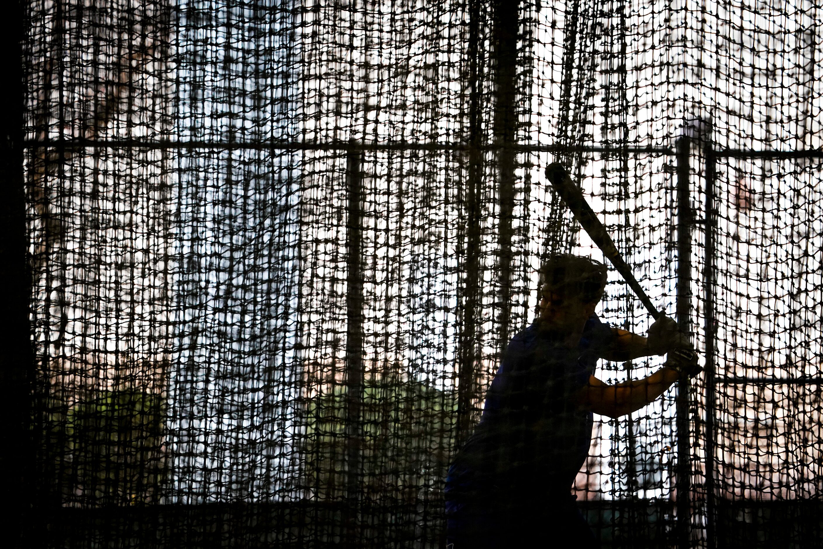 Texas Rangers infielder Greg Bird hits in the batting cage on the day pitchers and catchers...