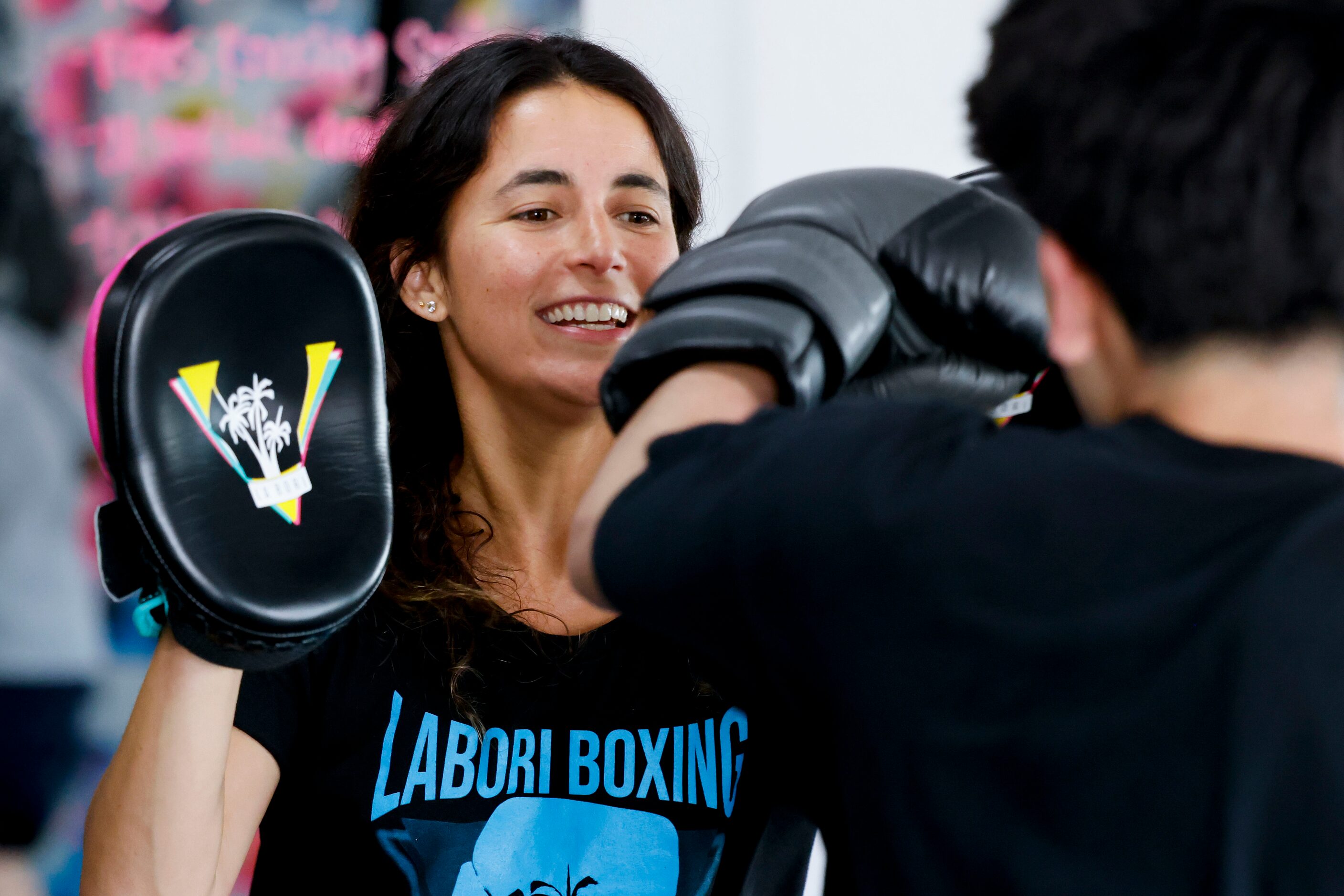 Amanda Alvarez, a salsa teacher and boxing lover, reacts as she trains Ivan Lopez during a...