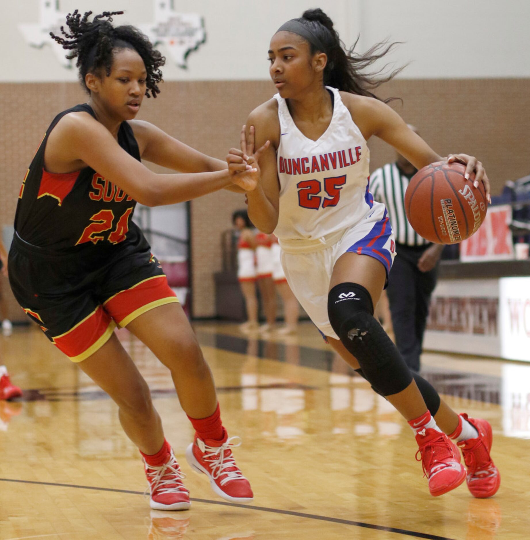 Duncanville guard Deja Kelly (25) drives to the basket as South Grand Prairie guard Vasanna...