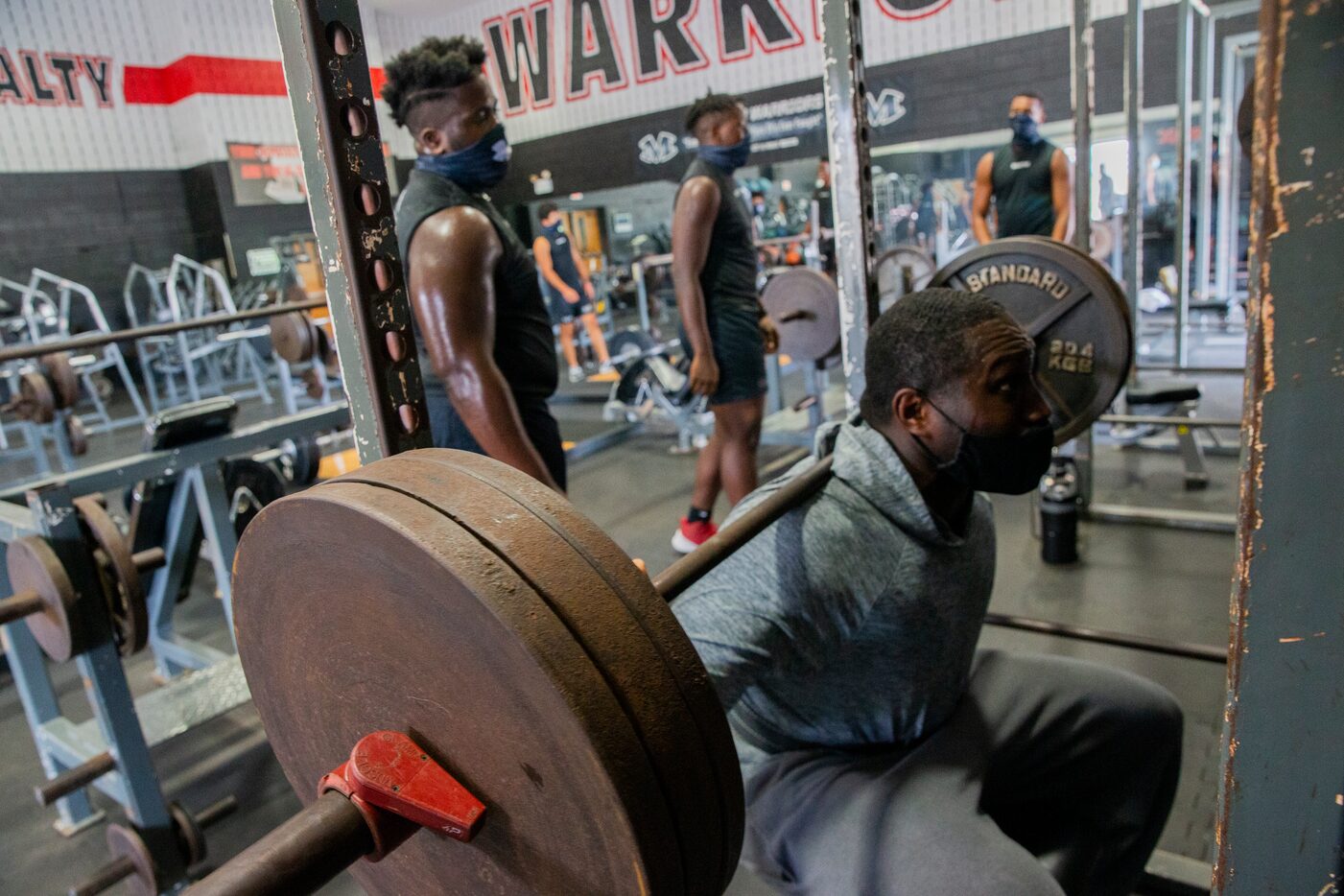 Homicide Sergeant Brian Jones from the Arlington Police Department squats as he works out...