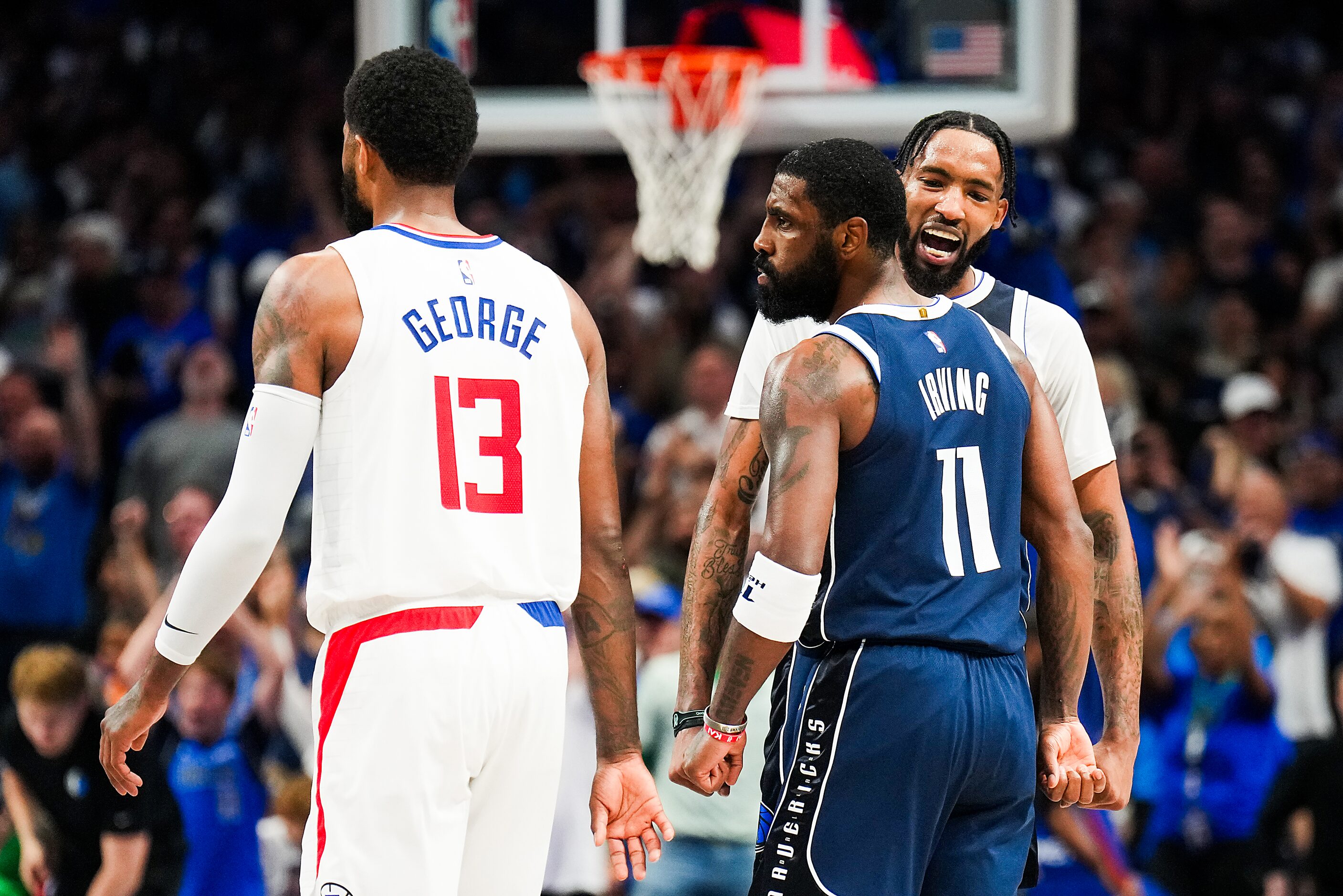 Dallas Mavericks guard Kyrie Irving (11) celebrates with forward Derrick Jones Jr. after...