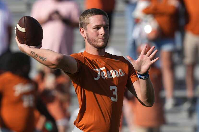 Texas quarterback Quinn Ewers passes during warmups before an NCAA college football game...