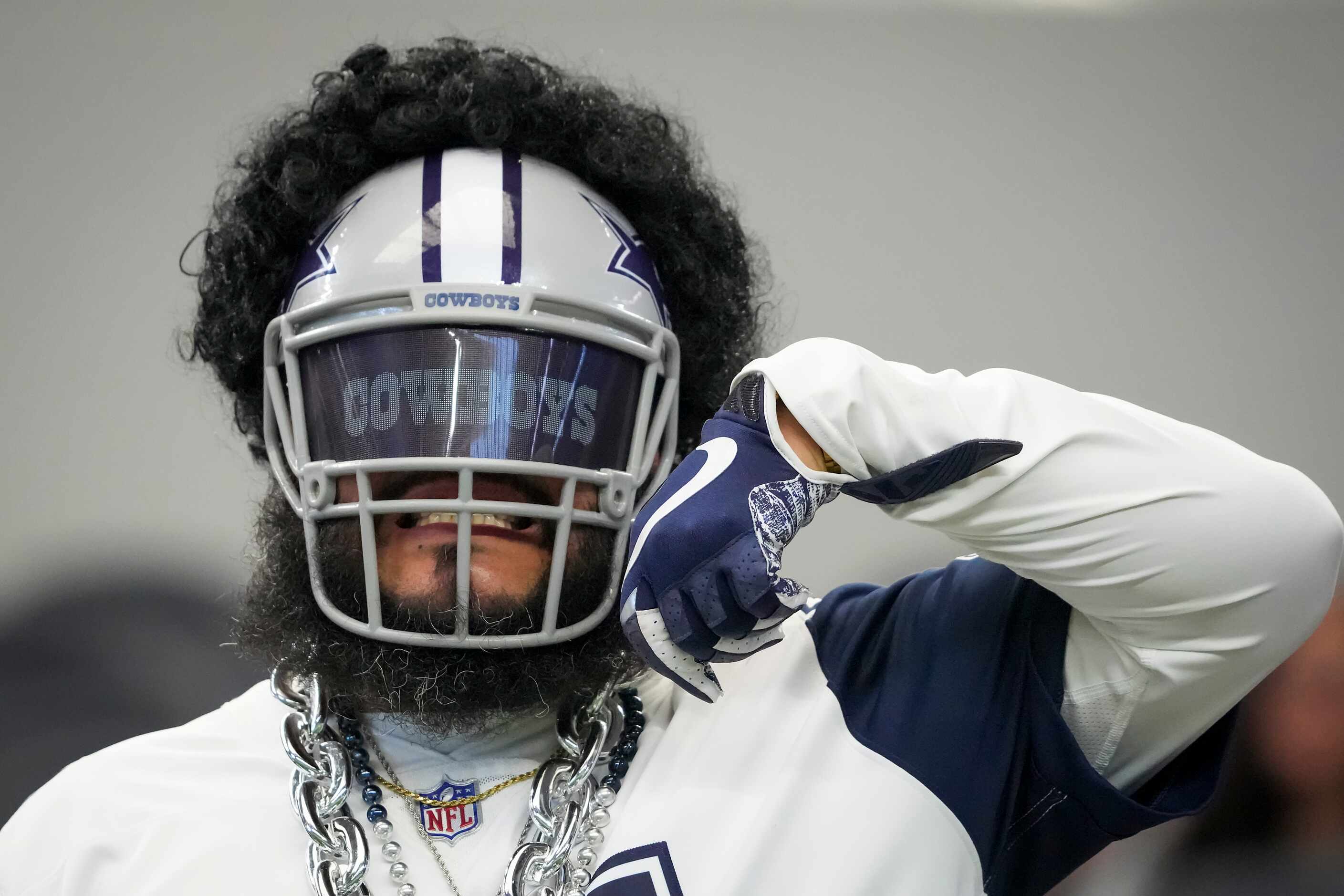A fan wears a Dallas Cowboys running back Ezekiel Elliott mask before an NFL football game...