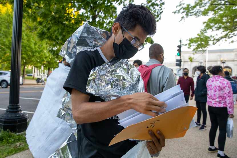 José Angel Mosquera, who came to the United States from Venezuela, sorted through his...