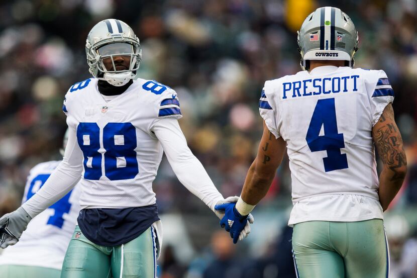 Dallas Cowboys wide receiver Dez Bryant (88) high-fives quarterback Dak Prescott (4) during...