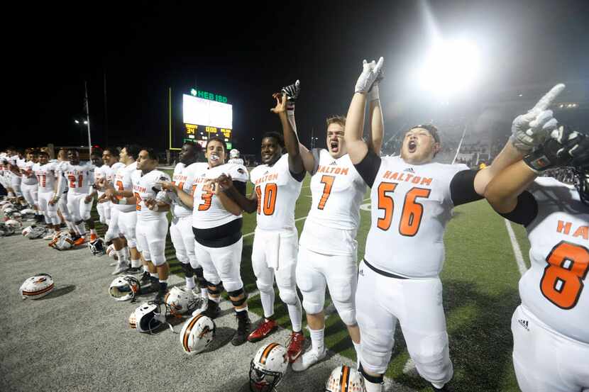 Haltom players react after they defeated Trinity 48-34 during their high school football...