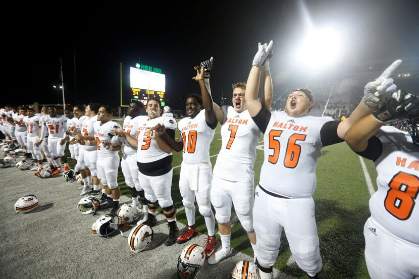 Haltom players react after they defeated Trinity 48-34 during their high school football...