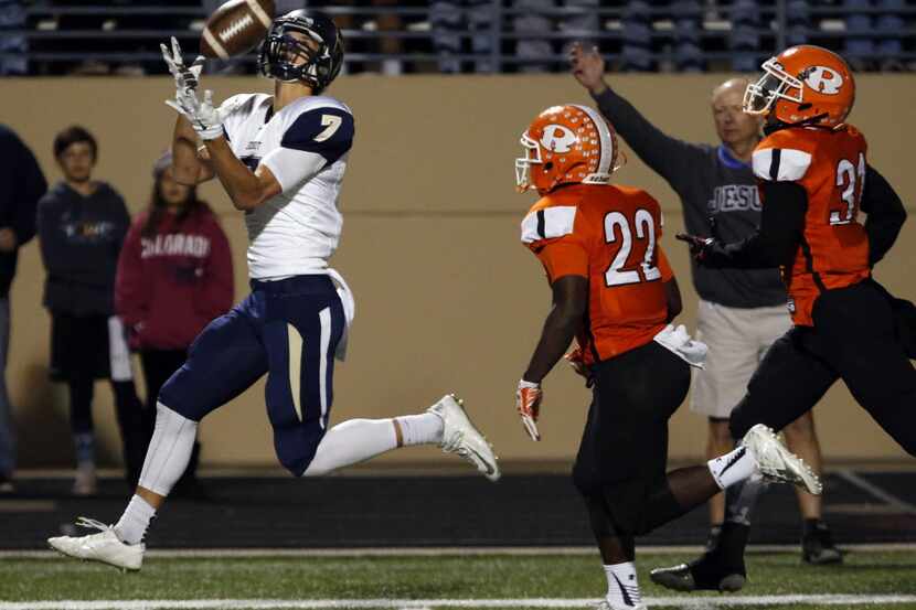 (TXHSFB) Jesuit's Conner Lanpher (7) gathers in a long touchdown pass, as Rockwall defenders...