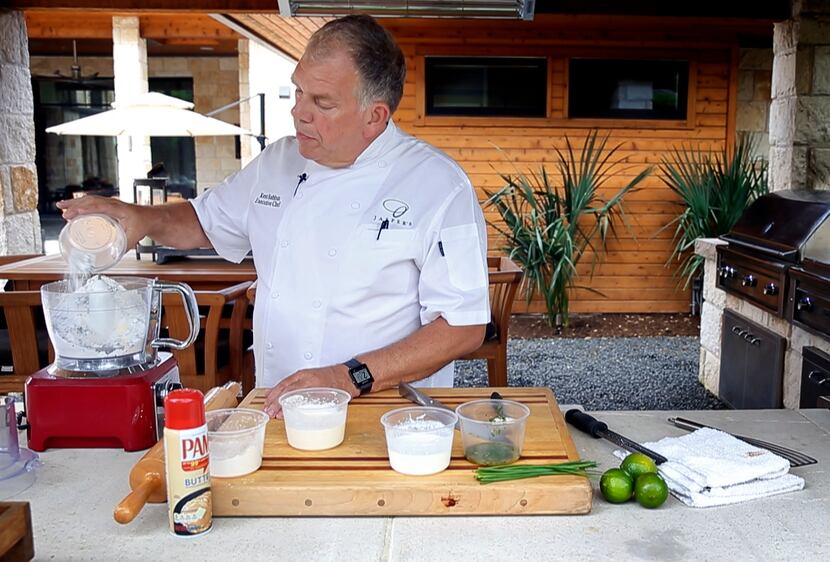 Chef Ken Rathbun dumps flour into a food processor as he makes ancho chili-lime biscuits at...