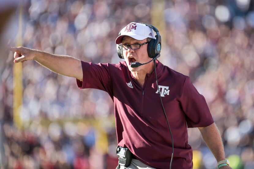 Texas A&M head coach Jimbo Fisher communicates with players during the first half of an NCAA...