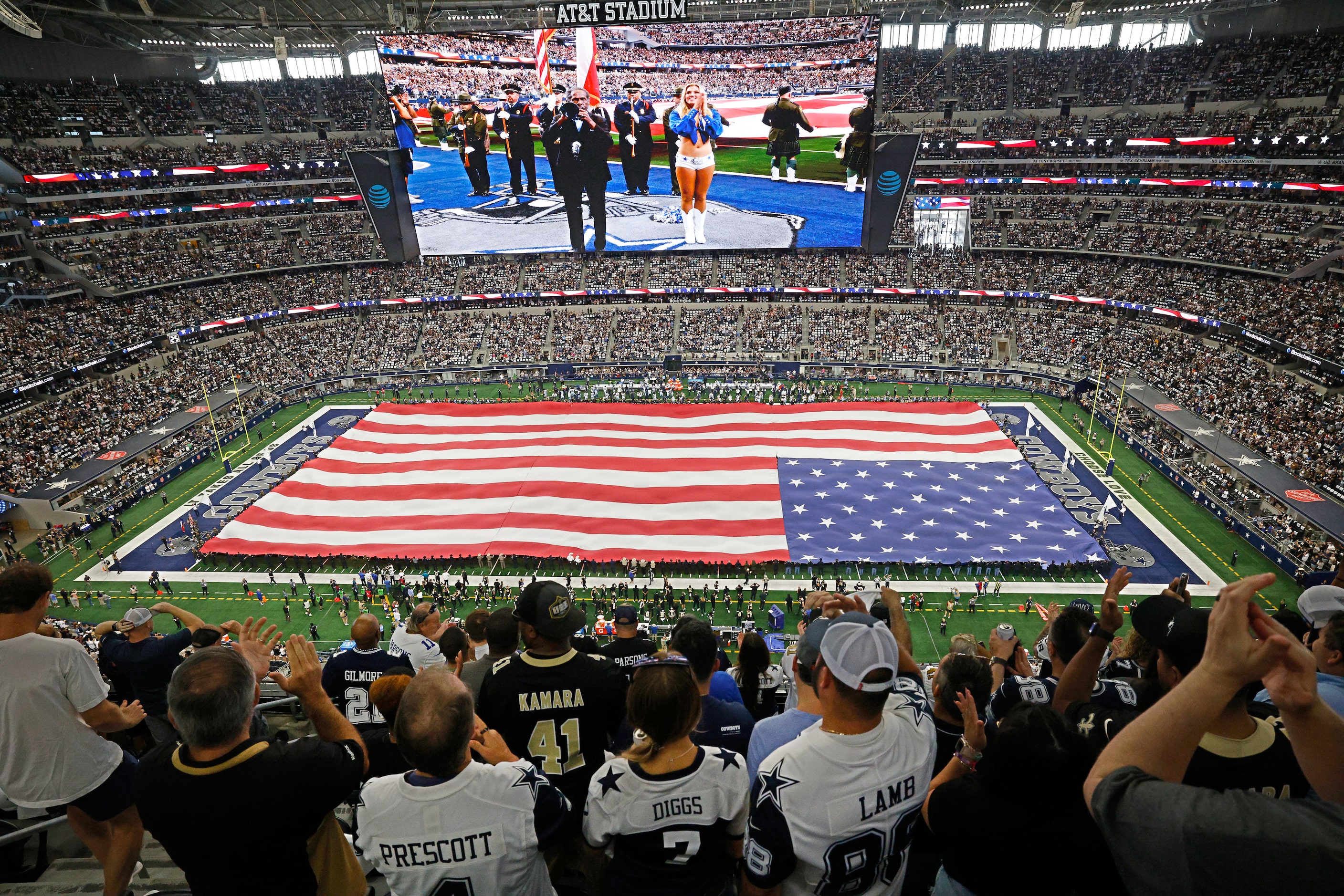 A huge American flag is presented during the national anthem before an NFL football game...