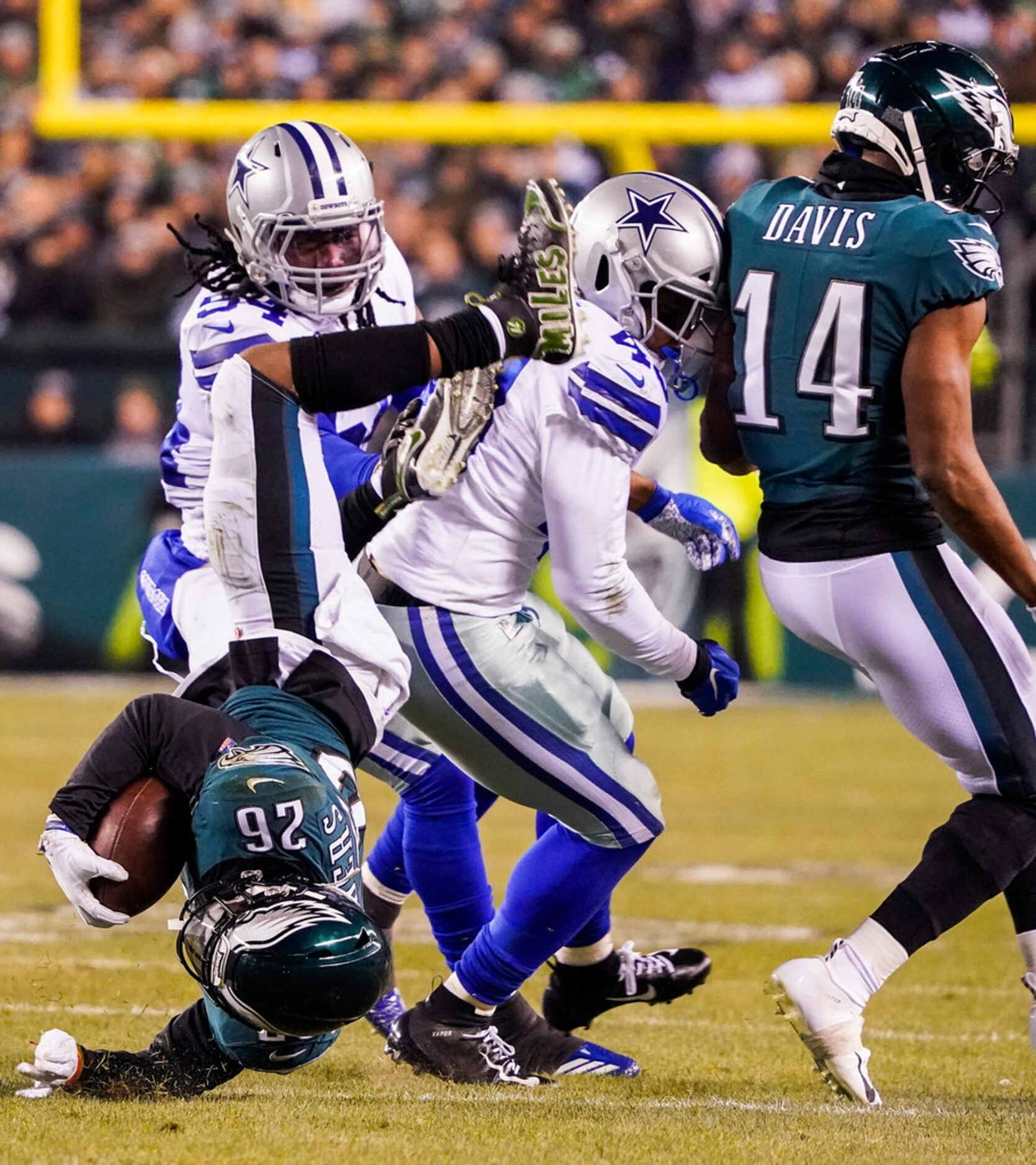 Philadelphia Eagles running back Miles Sanders (26) is knocked off his feet by Dallas...