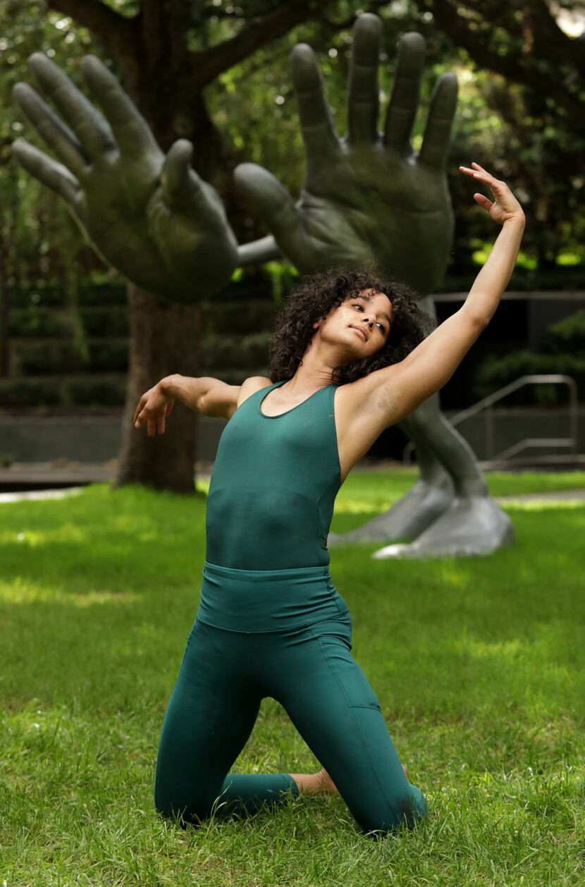 A dancer performs at Nasher Sculpture Center in front of Nic Nicosia's 'bighands' during...