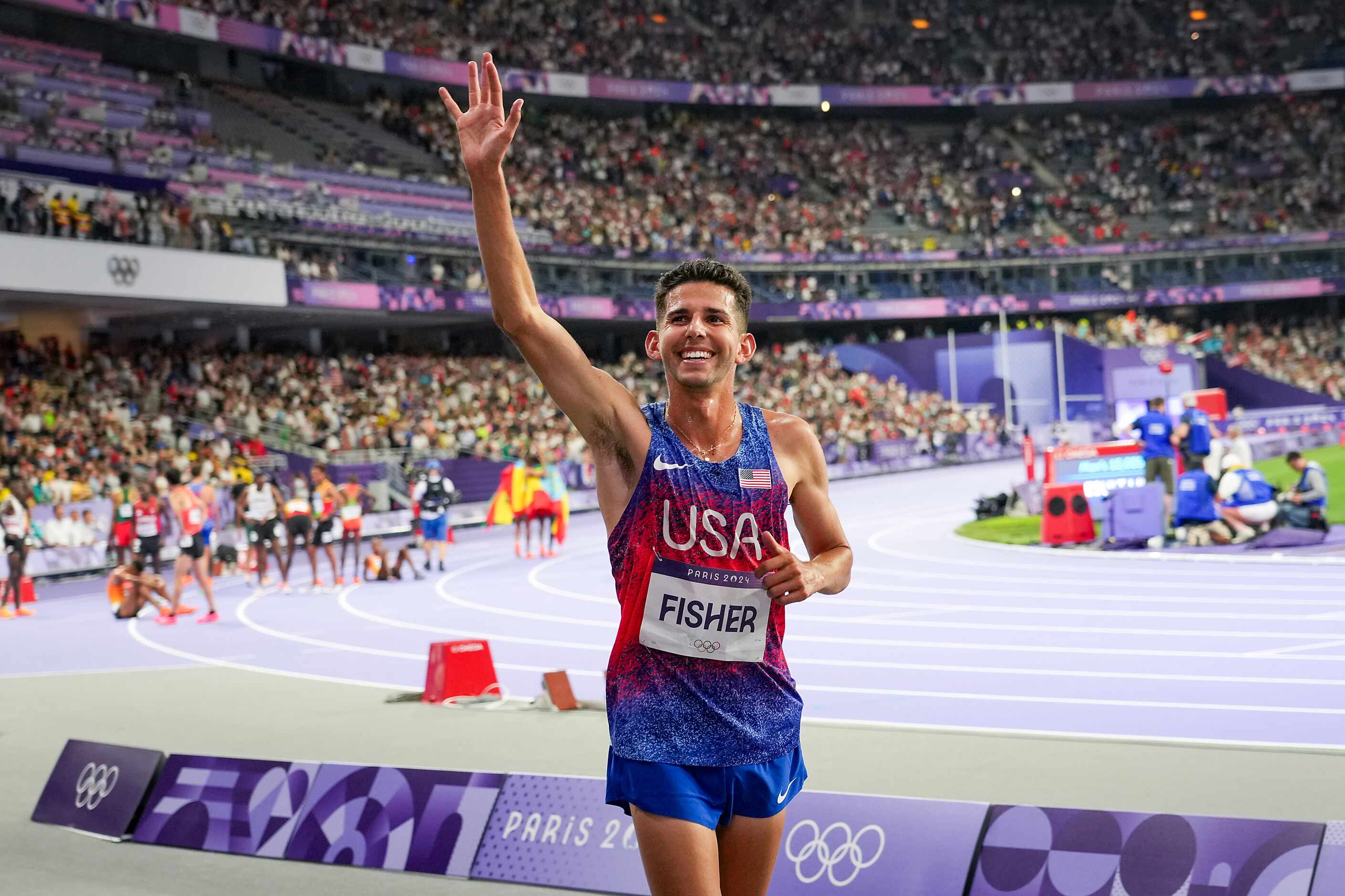 Grant Fisher of the United States celebrates after winning the bronze medal in the men’s...