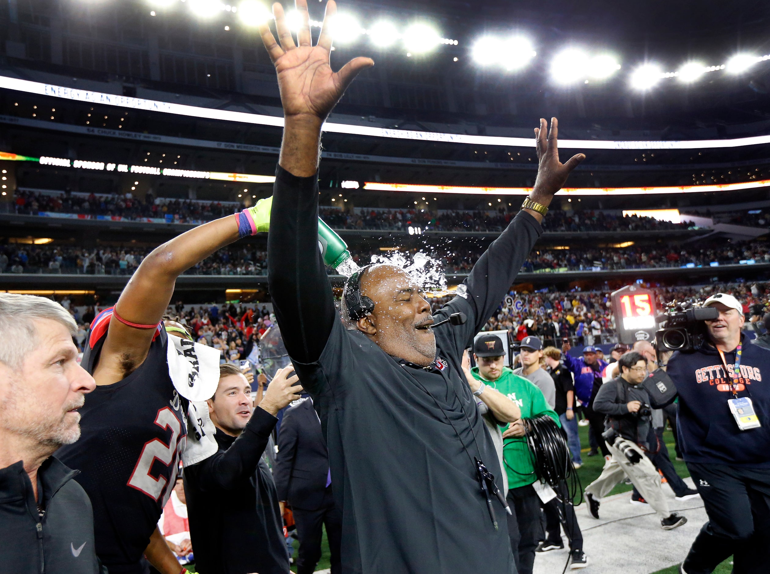 Duncanville head coach Reginald Samples is doused with water as he celebrates their Class 6A...