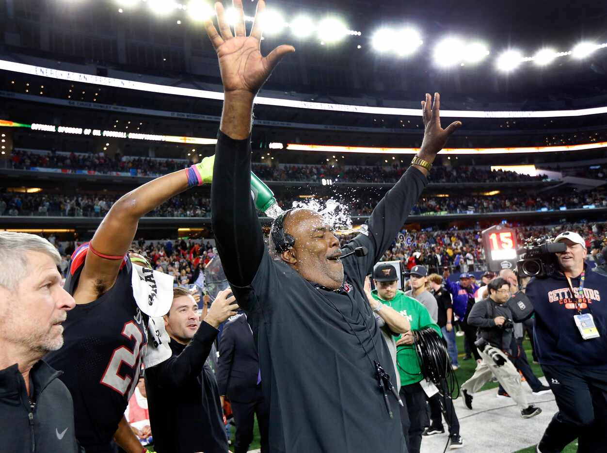 Duncanville head coach Reginald Samples is doused with water as he celebrates their Class 6A...