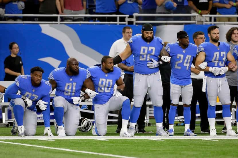 Members of the Detroit Lions knelt during the playing of the anthem before their game...