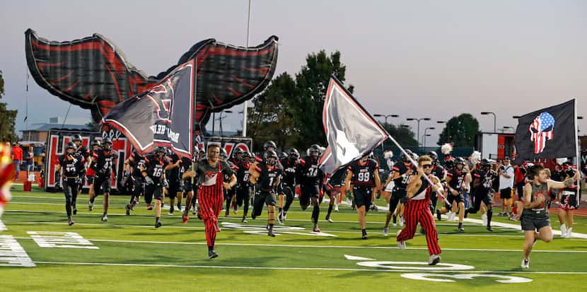 The Rockwall Heath Hawks take the field before the start of a high school football game...