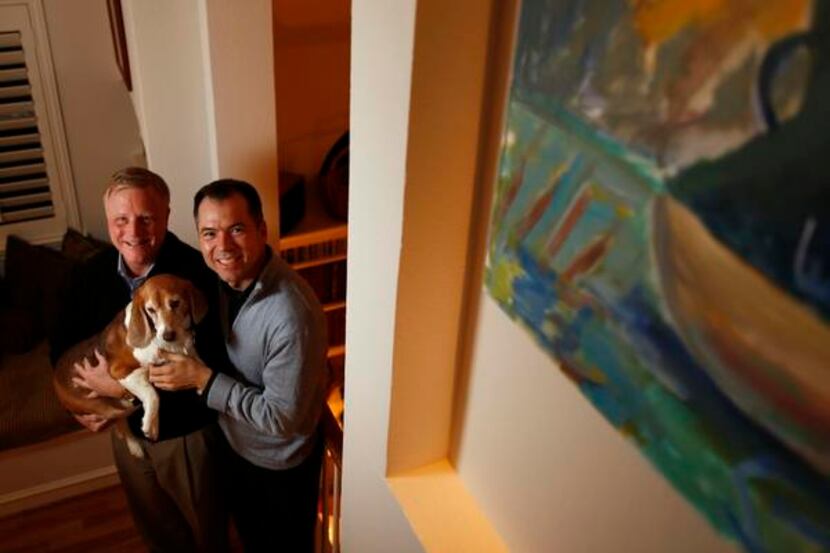 Mark Phariss and Vic Holmes hold Jake as they pose for a portrait in their home in Plano....