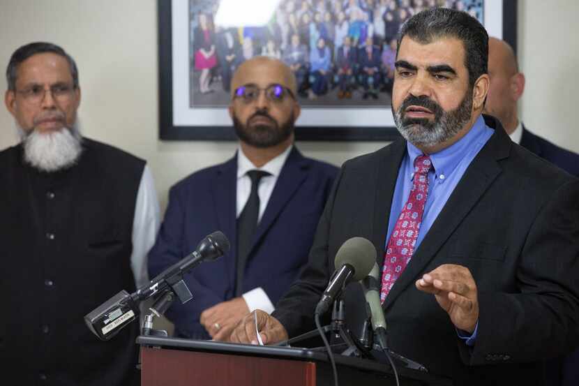 Muslim community leader Abderraoof Alkhawaldeh (right) speaks during a press conference at...