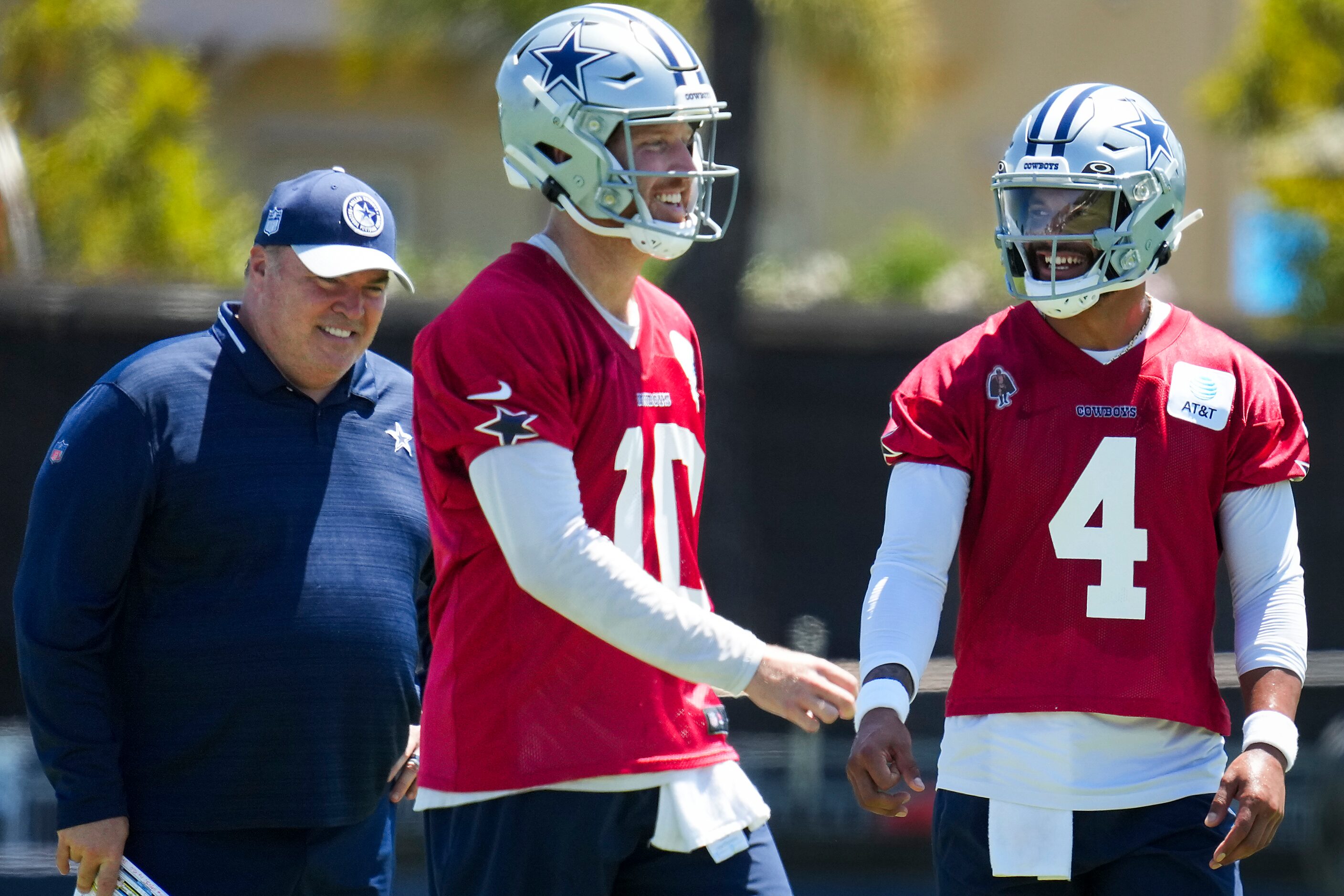 Dallas Cowboys quarterback Dak Prescott (4) laughs with quarterback Cooper Rush (10) and...