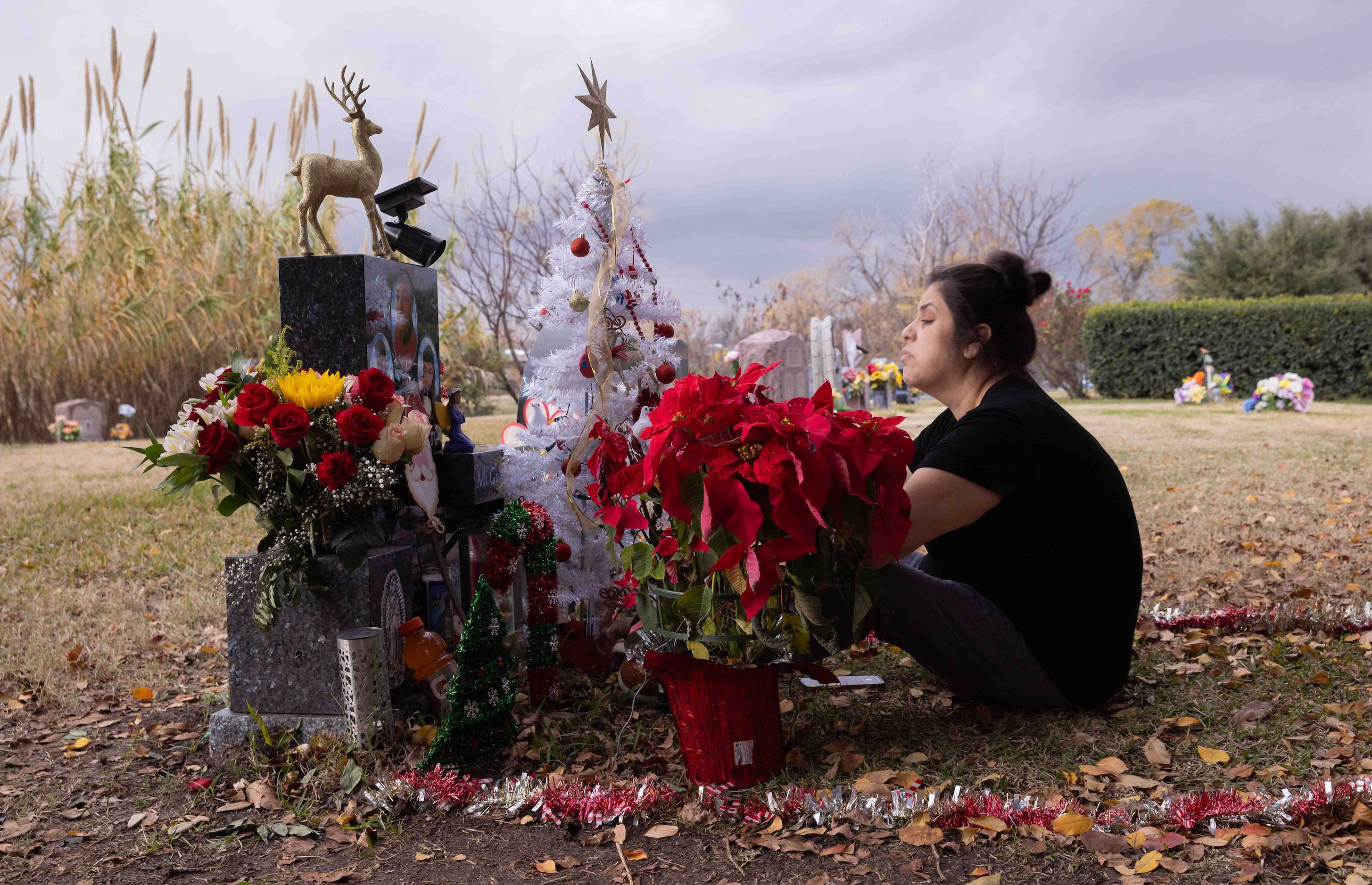 Ana Aguirre spends time at her son Isaac Aguirre’s gravesite, which is decorated for...