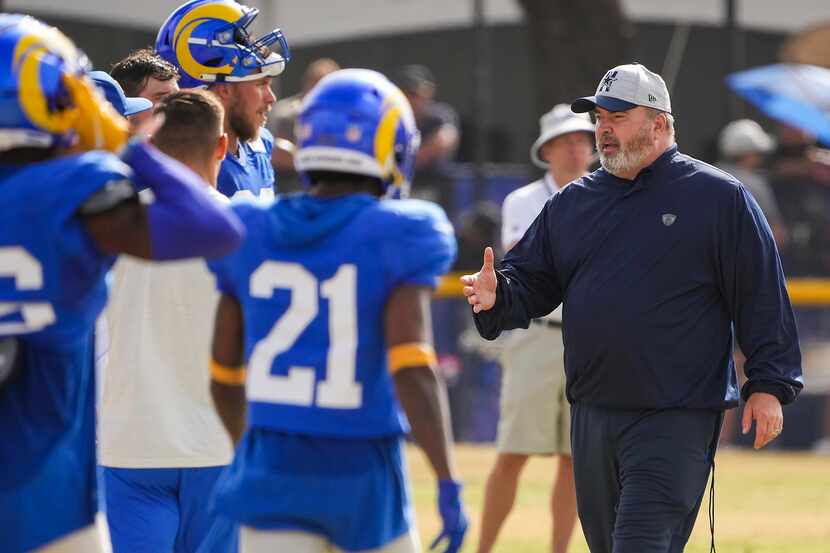 Dallas Cowboys head coach Mike McCarthy shakes hands with Los Angeles Rams players and...