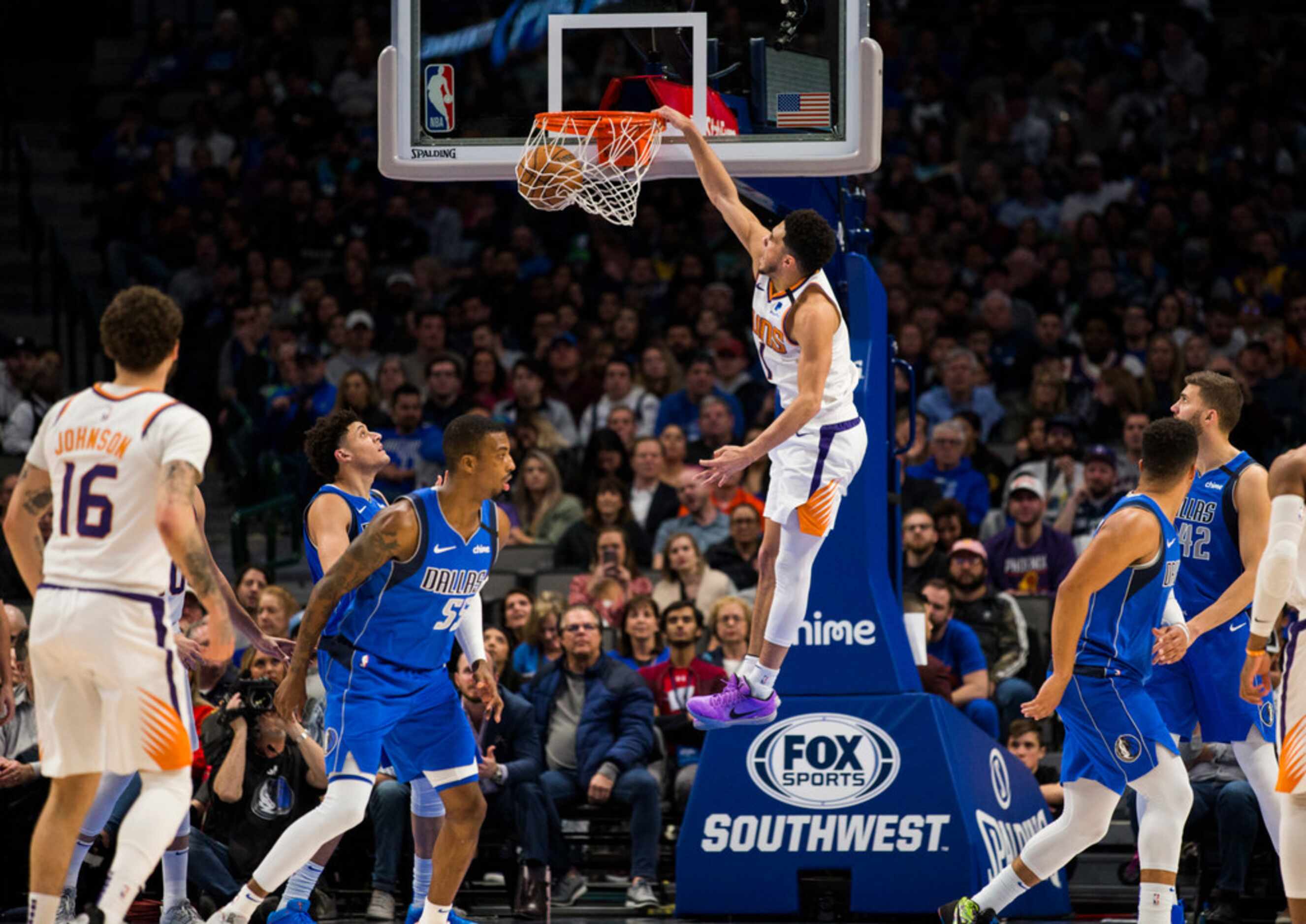 Phoenix Suns guard Devin Booker (1) dunks the ball during the third quarter of an NBA game...