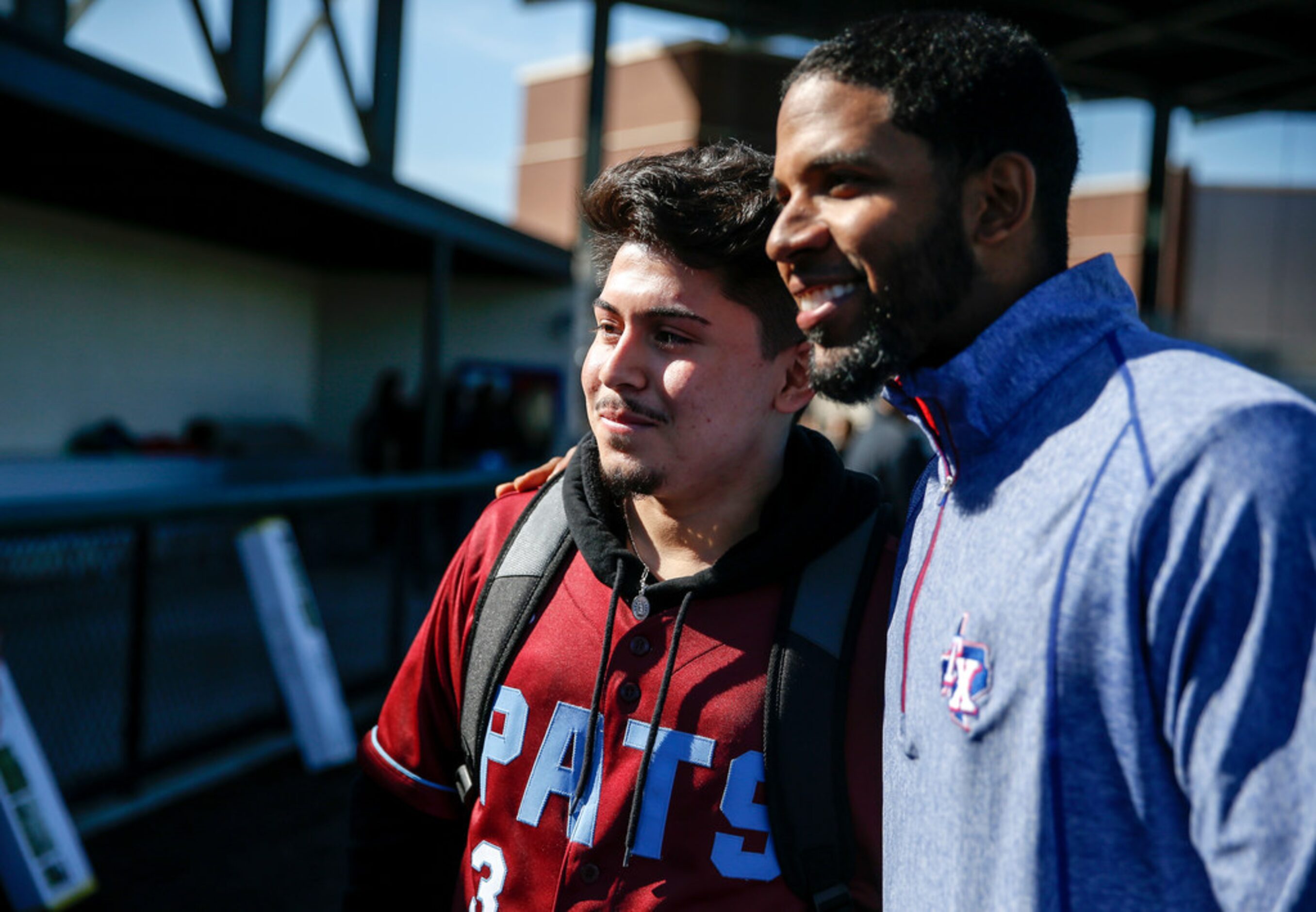 David Contreras, left, takes a photo with Rangers shortstop Elvis Andrus donates baseball...