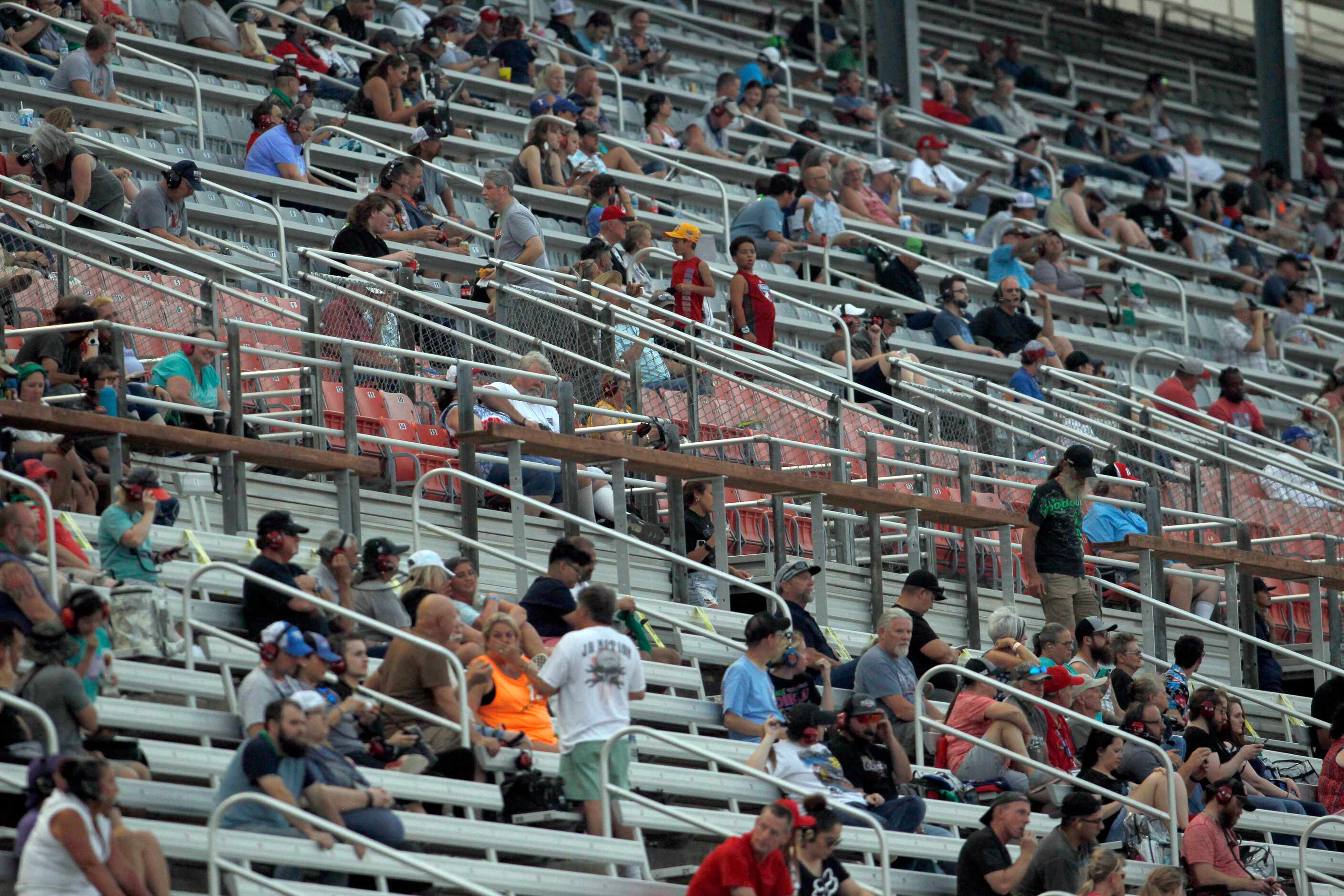 Fans locate their seats prior to the start of the NASCAR Trucks Speedycash.com 220 race was...