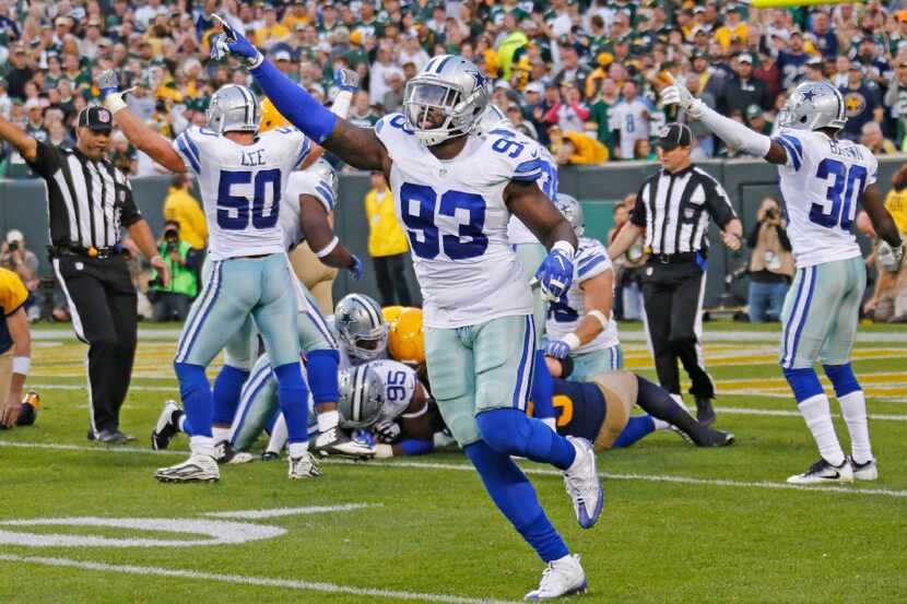 Dallas Cowboys defensive end Benson Mayowa (93) signals Cowboys recovery of an Aaron Rodgers...
