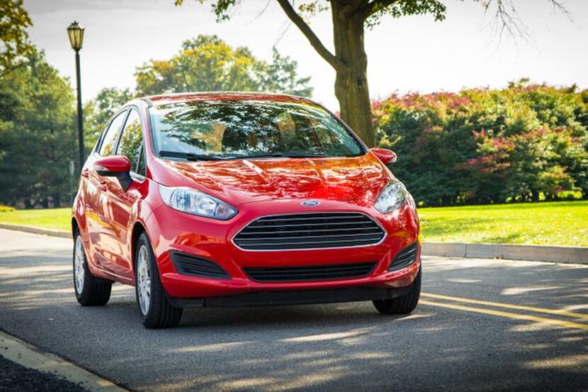 The 2014 Ford Fiesta  wears Ford’s signature five-bar Aston Martin look-alike grille and...