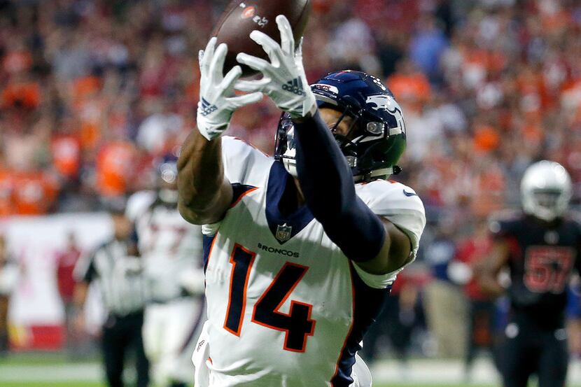 Denver Broncos wide receiver Courtland Sutton (14) pulls in a touchdown pass form teammate...