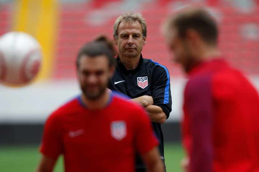 United States coach Jurgen Klinsmann watches as his players train at the National Stadium,...