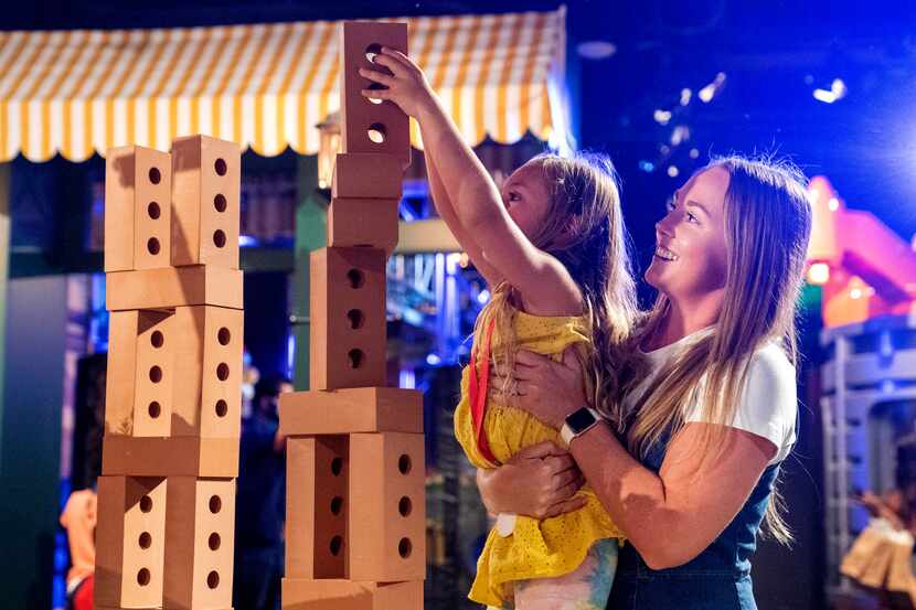 Heather Torregrossa helps her 6-year-old daughter Emersyn Torregrossa build a tower of toy...