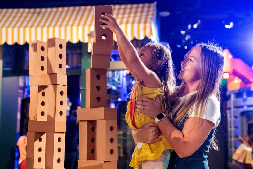 Heather Torregrossa helps her 6-year-old daughter Emersyn Torregrossa build a tower of toy...