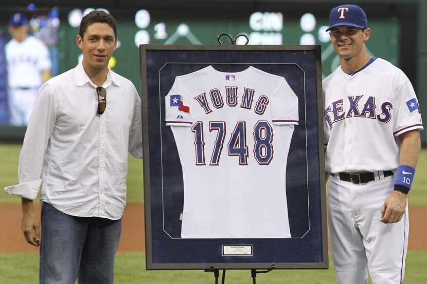 Texas 3B Michael Young poses with GM Jon Daniels during pregame ceremonies honoring Young as...