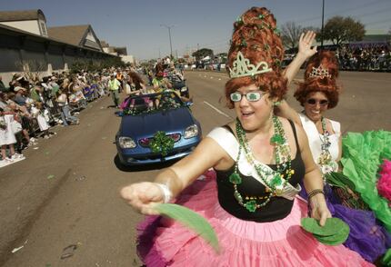 Texas Tortilla Queens Stacie Collins, center, and Denise Koval, right, throw green tortillas...