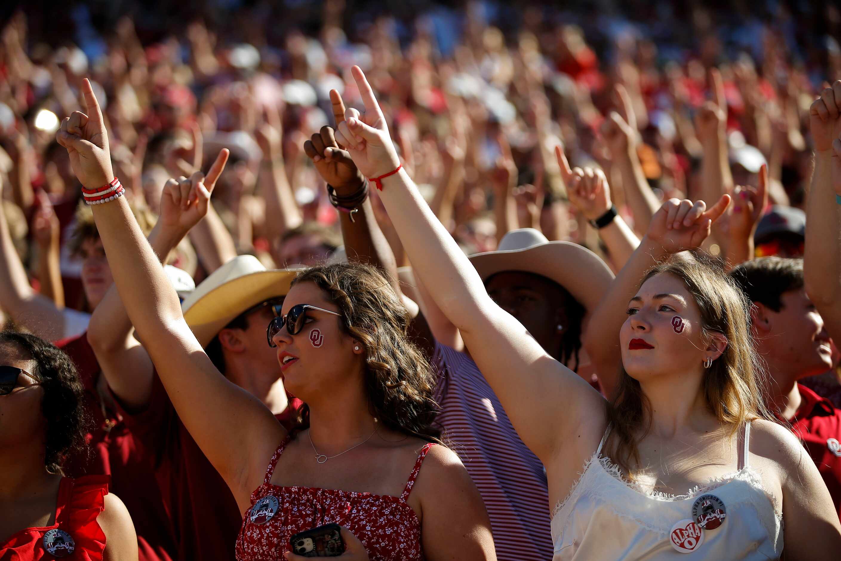 Oklahoma fans cheer for their team during the first half of an NCAA college football game...