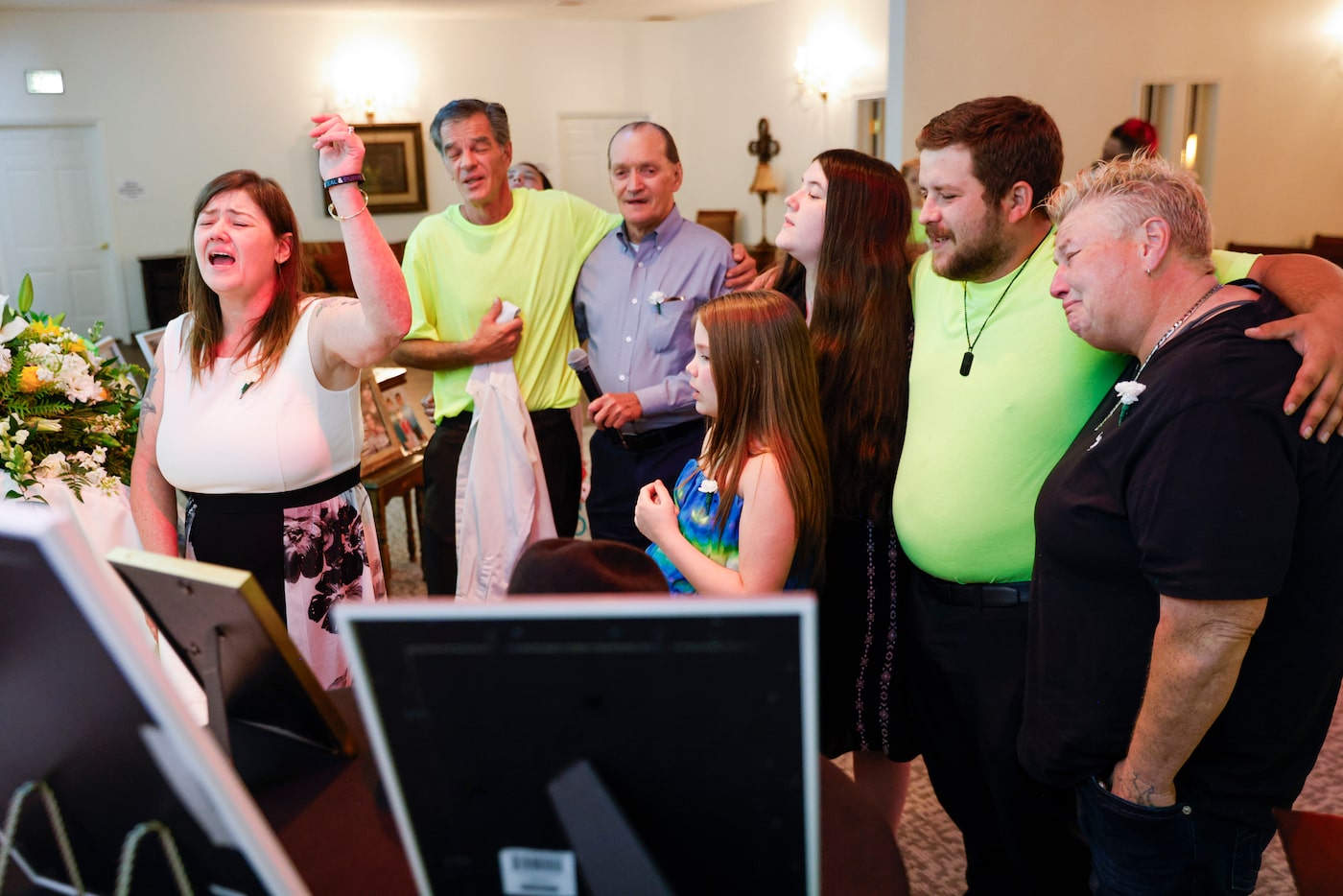 From left, surrounding the casket, Tona Southards, mother of Jon Anthony Southards, leads a...