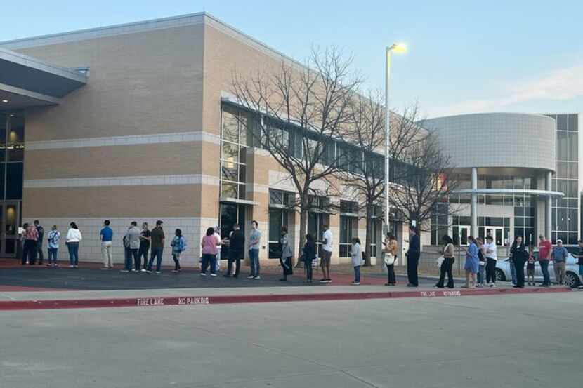 The line to vote at the Collin College Frisco Campus extended into the parking lot about...