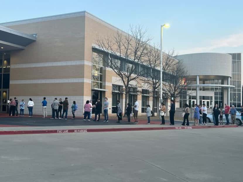 The line to vote at the Collin College Frisco Campus extended into the parking lot about...