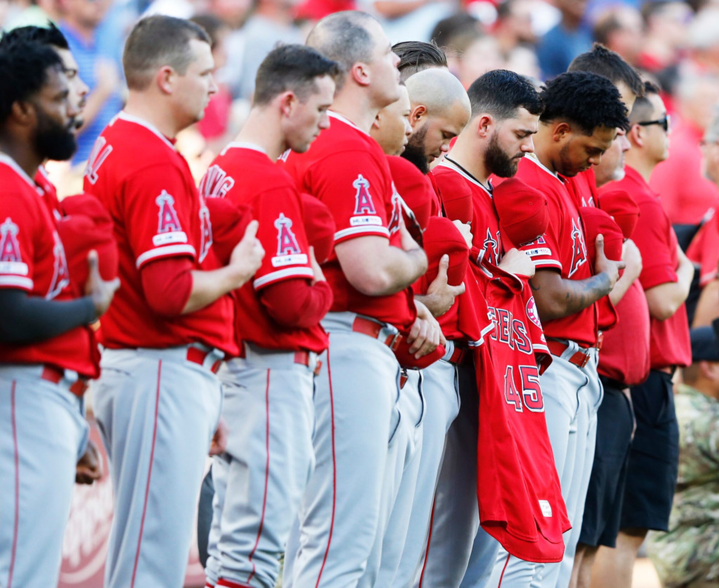 The jersey of Los Angeles Angels Tyler Skaggs (45) is held by teammates during a moment of...